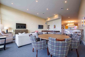 a living room with a table and chairs